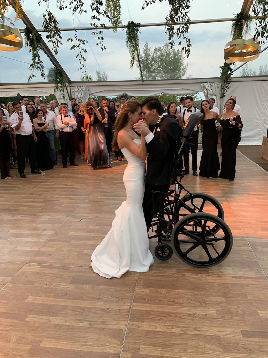 Marc Byron using a standing wheelchair to dance with his daughter Jenna at her wedding.