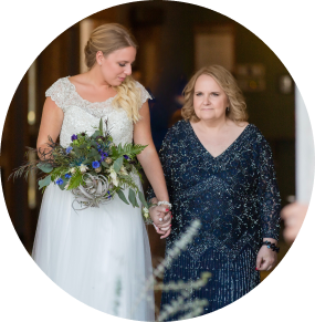 image of former care partner Amy on her wedding day, walking with her mother