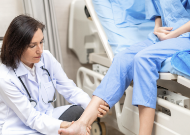 image of doctor examining patient's ankle