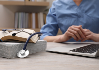 image of person with laptop and medical books